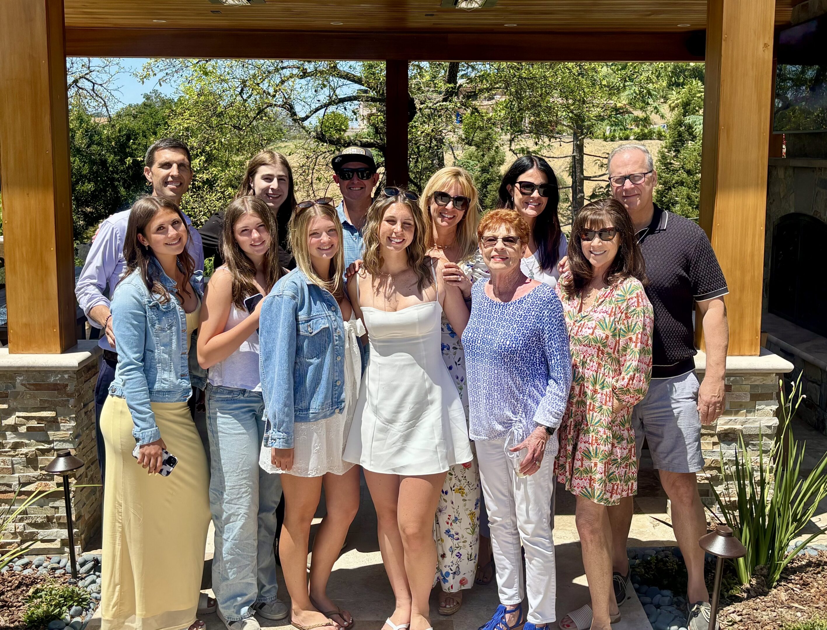 Multigenerational group smiling outdoors on patio